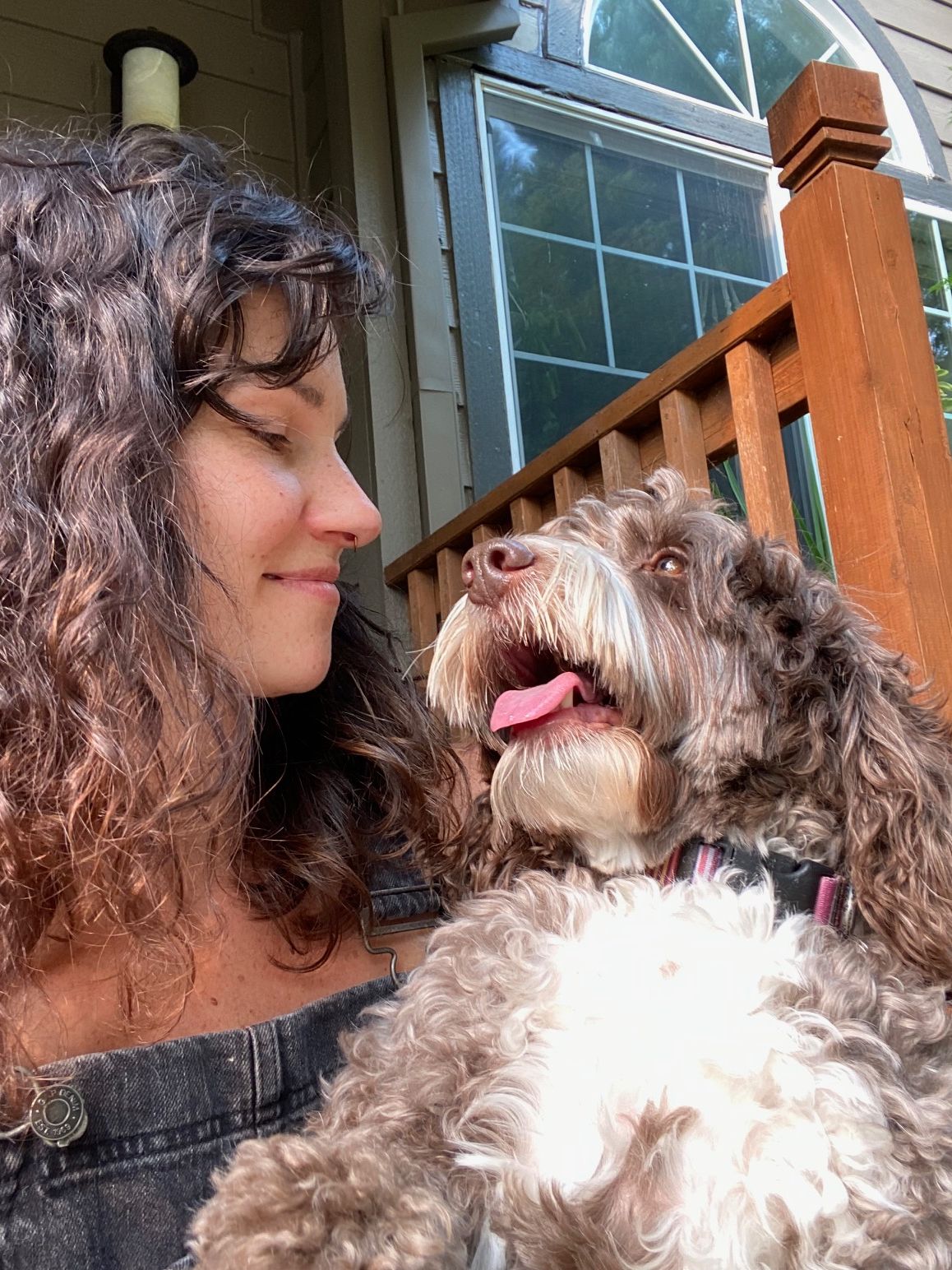 Tera Pareja with her emotional support dog on a front porch